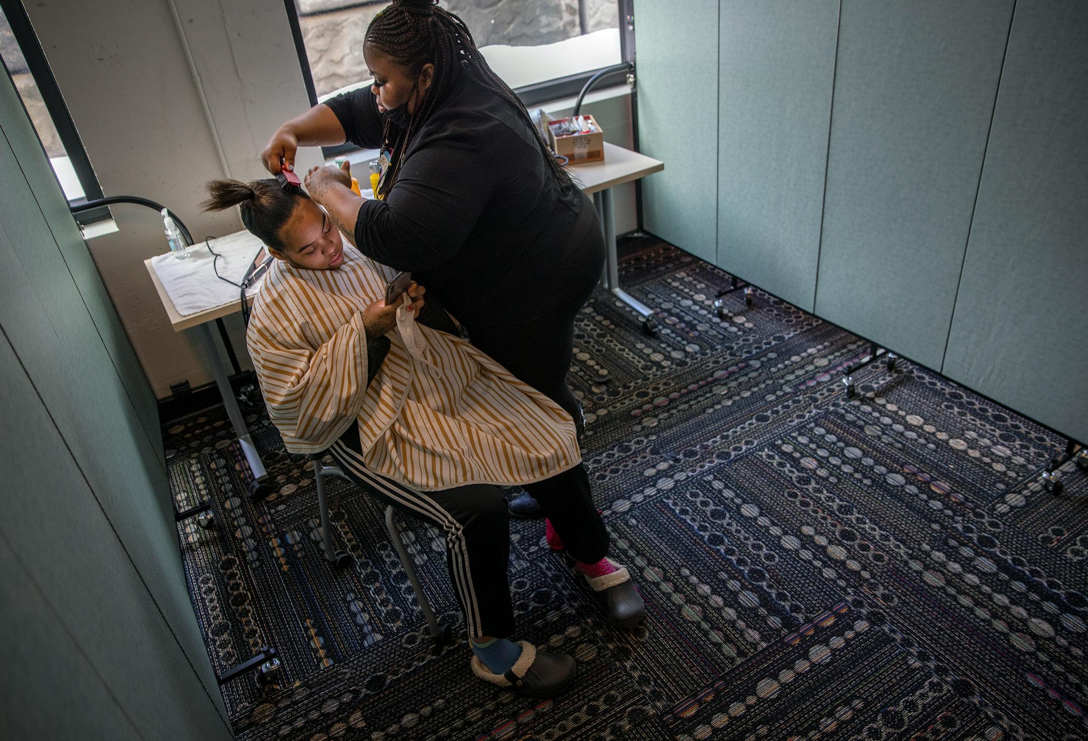 Nesha Thomas, a freelance stylist, worked on Tamaira Presley's hair during the Kings and Queens Day event at YouthLink, Wednesday, February 24, 2021 in Minneapolis.