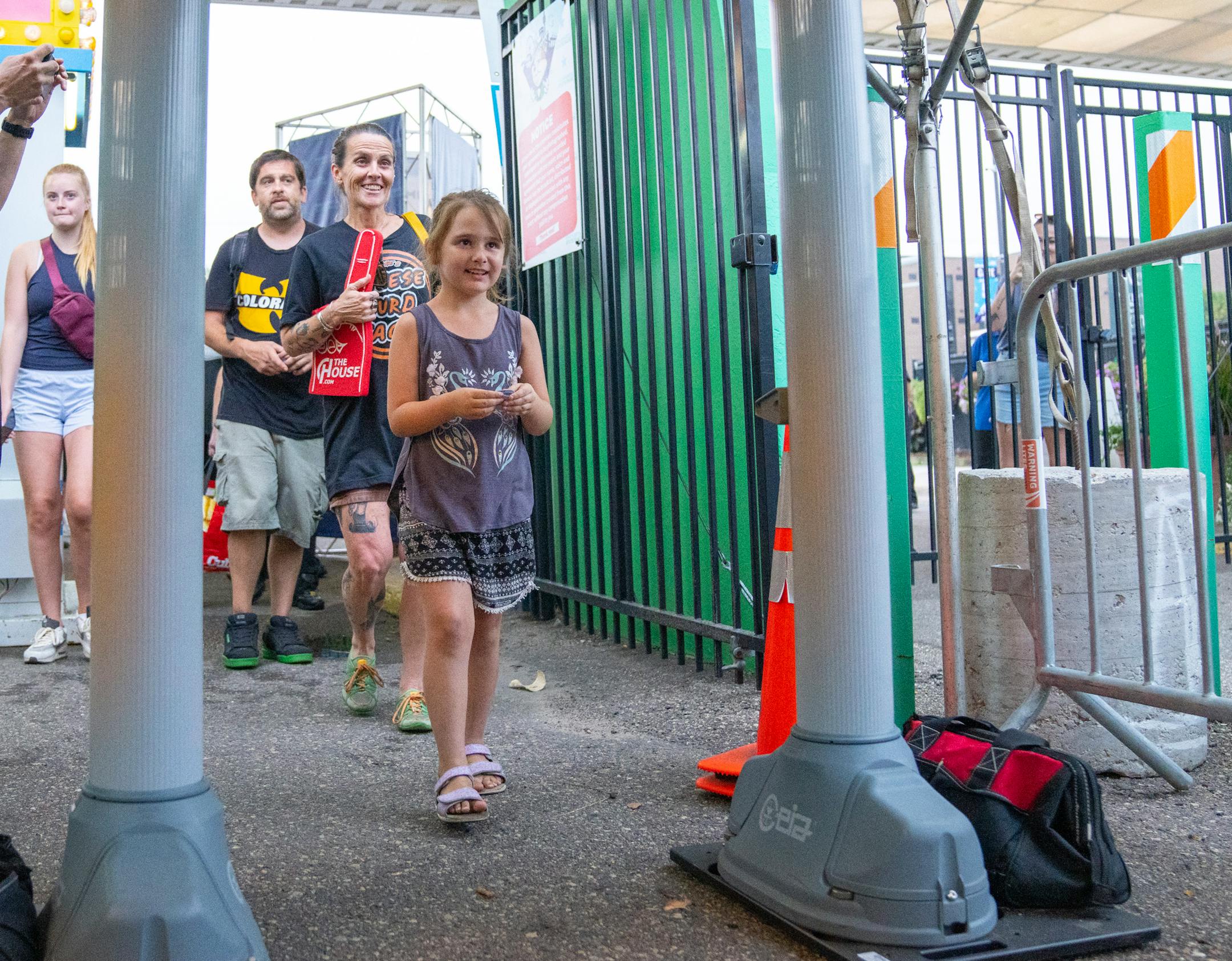 Maryjane Burgett, 6, of St. Paul, walks through metal detectors at the gates of the Minnesota State Fair on Thursday, Aug. 24, 2023, in Falcon Heights, Minn. At precisely 7 a.m., the gates are opened and fairgoers are let into the State Fairgrounds.