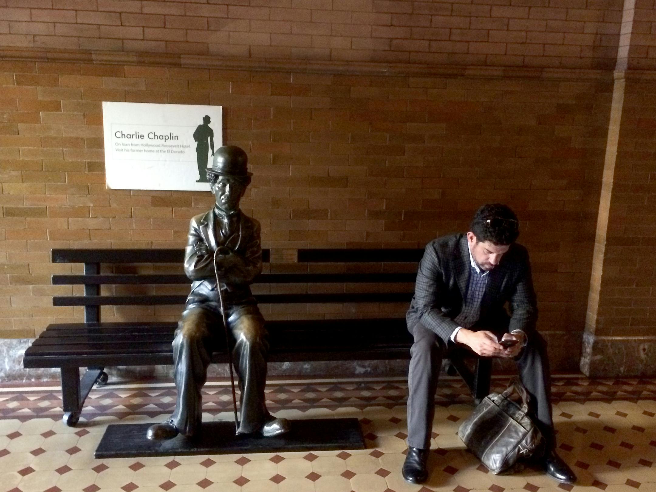 LA6) Charlie Chaplin and friend sit amid the Italian Renaissance Revival glory in the Bradbury Building.