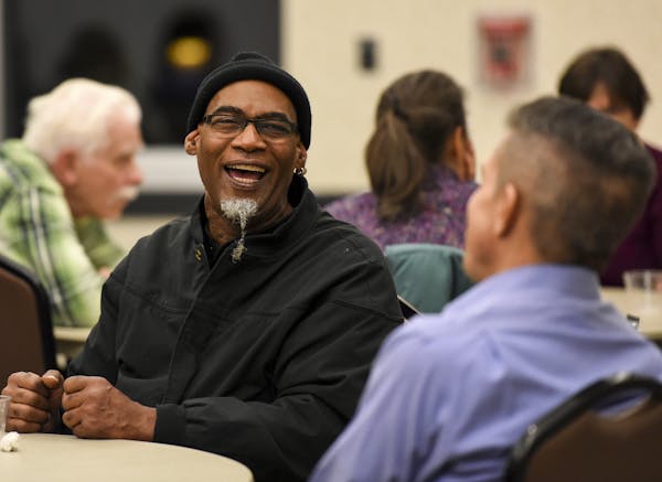 Anthony Mills, of Coon Rapids, shared a laugh with Coon Rapids Police Chief Brad Wise during November's "Transformative Circle" discussion at the Coon