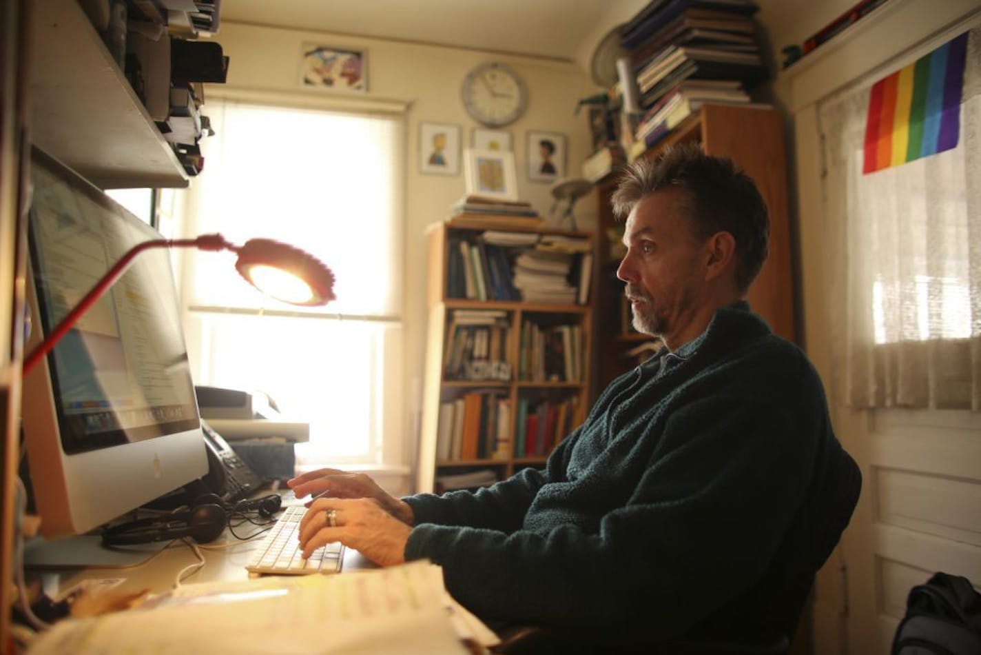 John Gustav-Wrathall telecommutes from his home in the Powderhorn Park neighborhood of Minneapolis to his job as a paralegal for a downtown patent law firm. Gustav-Wrathall worked in his home office Wednesday afternoon, March 6, 2013.