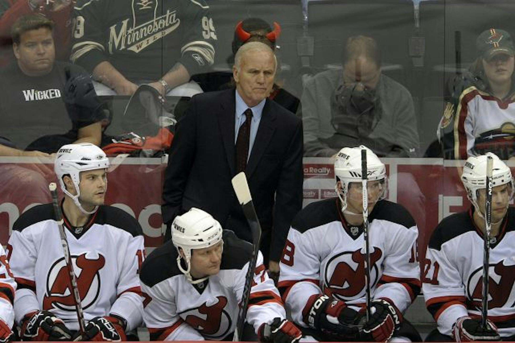 New Jersey Devils head coach Jacques Lemaire, center, watches play against his former team, the Minnesota Wild, during the second period of an NHL hockey game Saturday, Jan. 2, 2010, in St. Paul, Minn. New Jersey won 5-3.