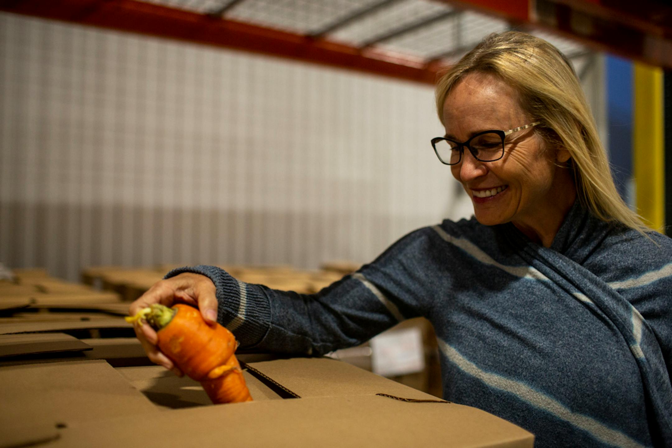 Produce strategy manager Heidi Coe was amused by the appearance of an oddly shaped carrot at Second Harvest Heartland's Brooklyn Park warehouse.