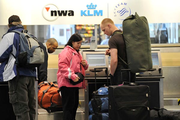 Passengers checked in Tuesday morning at the Northwest Airlines ticket counter in the Minneapolis-St. Paul International Airport, one day after NWA an