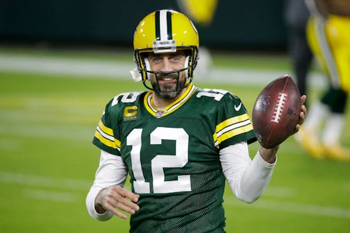 FILE - Green Bay Packers' Aaron Rodgers warms up before an NFL football game against the Chicago Bears in Green Bay, Wis., in this Sunday, Nov. 29, 2020, file photo. Shailene Woodley confirmed that she's engaged to Rodgers. The actor discussed her relationship with Rodgers on "The Tonight Show Starring Jimmy Fallon" on Monday, Feb. 22, 2021, saying they got engaged "a while ago." The 37-year-old Rodgers mentioned his engagement and thanked his fiancée while accepting his third career MVP award on Feb. 6 but didn't say her name. (AP Photo/Mike Roemer, File)