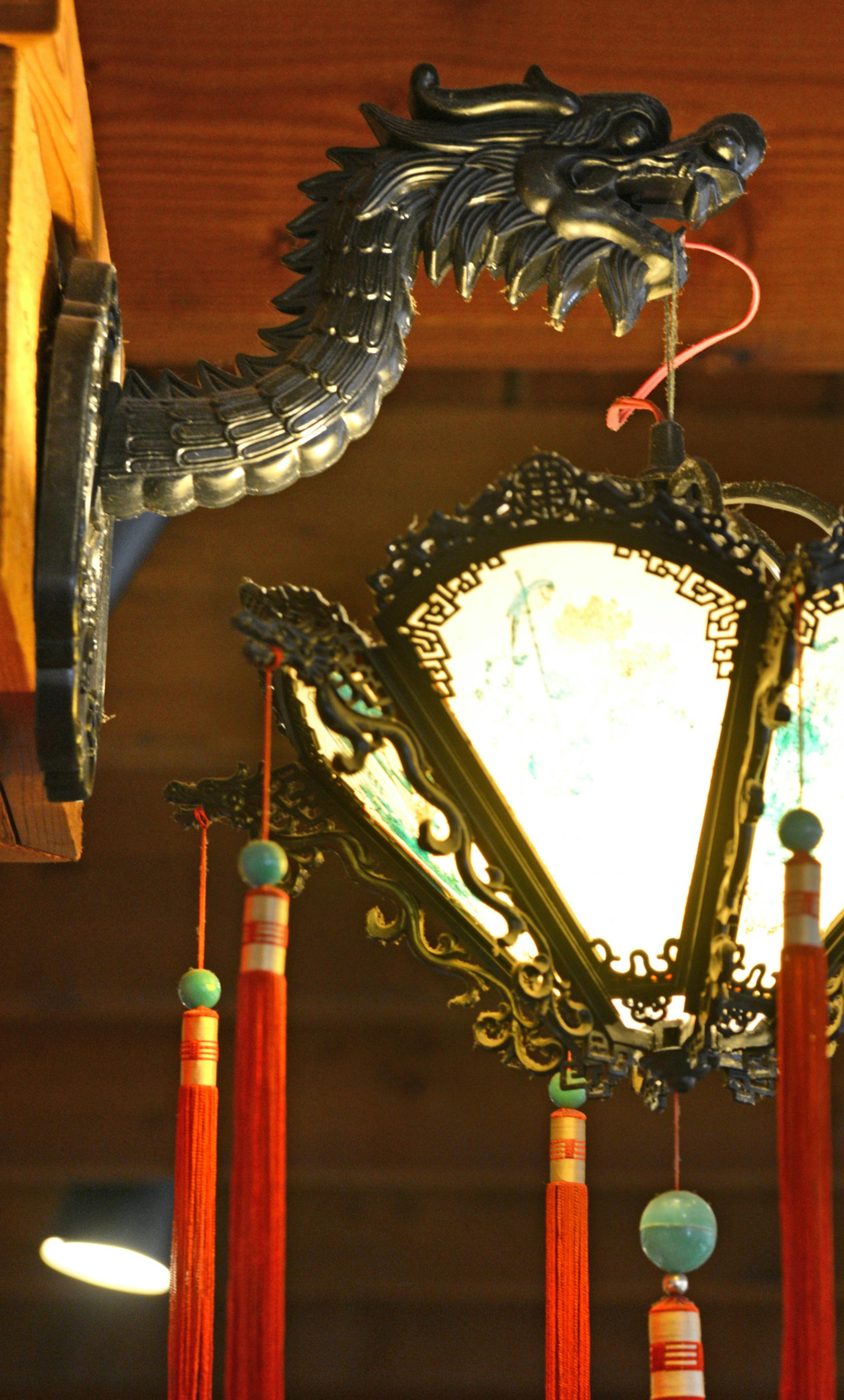 The Dragon House Restuarant is a fixture on Central Ave in Columbia Heights . This this dragon holds a lantern in the main restuarant. ] Ethnic restaurants and grocery stores line Central Avenue in Columbia Heights, drawing community members and commuters alike to sample different cultures' cuisines. Richard.Sennott@startribune.com Richard Sennott/Star Tribune Columbia Heights , Minn. Tuesday 3/11/2014) ** (cq)