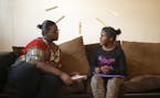 Tiffany Morgan helped her 9-year-old daughter Ny'Ana, who has fetal alcohol syndrome, with her homework after school Monday afternoon. She had to writ