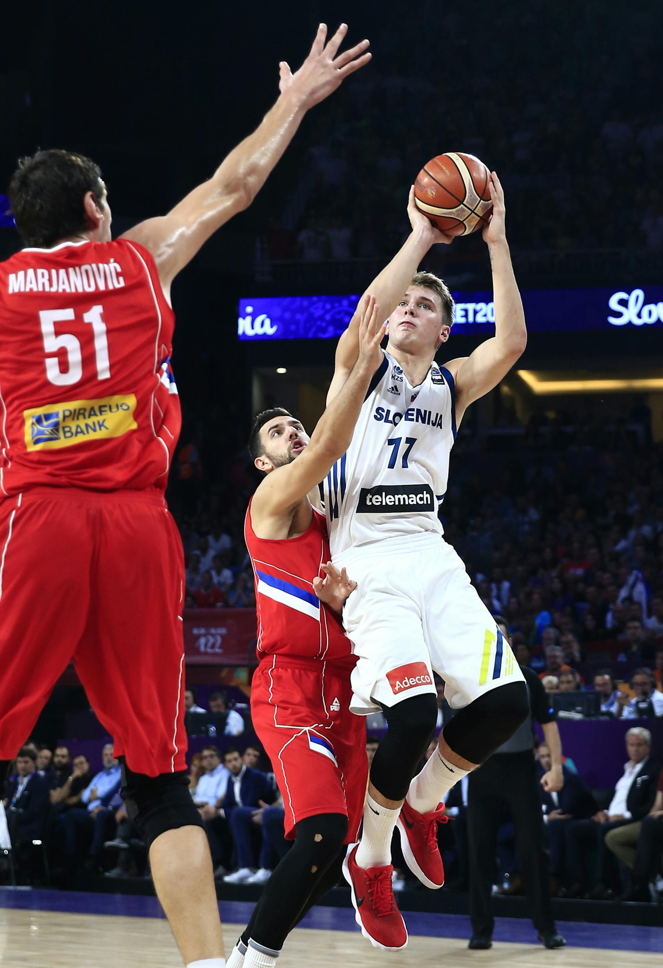 FILE - In this Sept. 17, 2017, file photo, Slovenia's Luka Doncic, right, shoots a basket as Serbia's Vasilje Micic tries to stop him during their Eurobasket European Basketball Championship final match in Istanbul. (AP Photo/Lefteris Pitarakis, File)