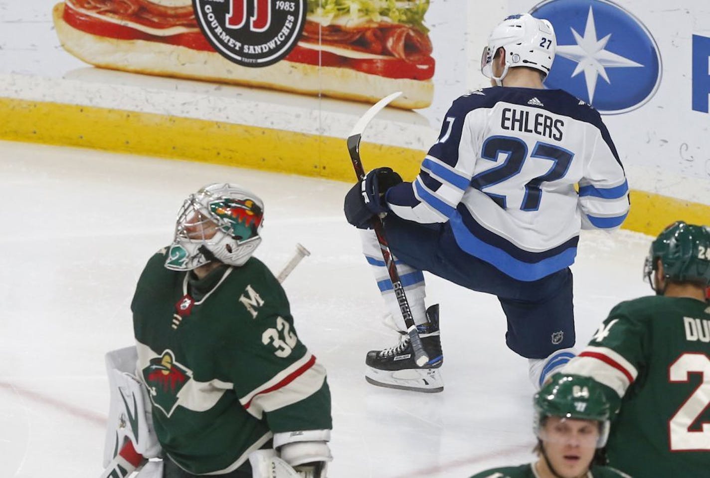 Winnipeg Jets' Nikolaj Ehlers, right, of Denmark, celebrates as he scores on Minnesota Wild goalie Alex Stalock, left, during the third period of an NHL hockey game Tuesday, Oct. 31, 2017, in St. Paul, Minn. The Jets won 2-1.