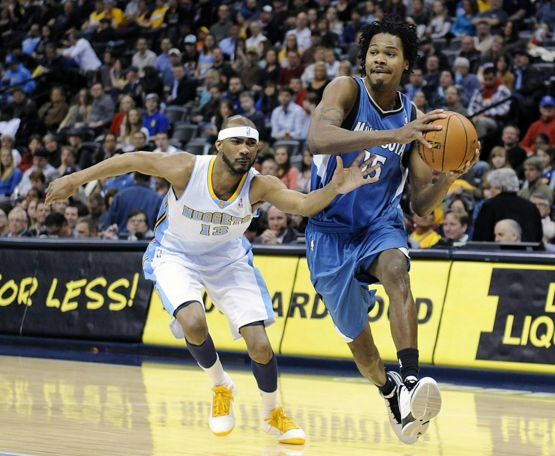 Denver Nuggets forward Corey Brewer, left, tries to defend Minnesota Timberwolves forward Mickael Gelabale during the first quarter of an NBA basketball game Saturday, March 9, 2013, in Denver.