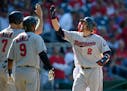 The Twins' Brian Dozier (2) celebrated his three-run home run with Joe Mauer (7) and Eduardo Nunez during the eighth inning against the Nationals, but