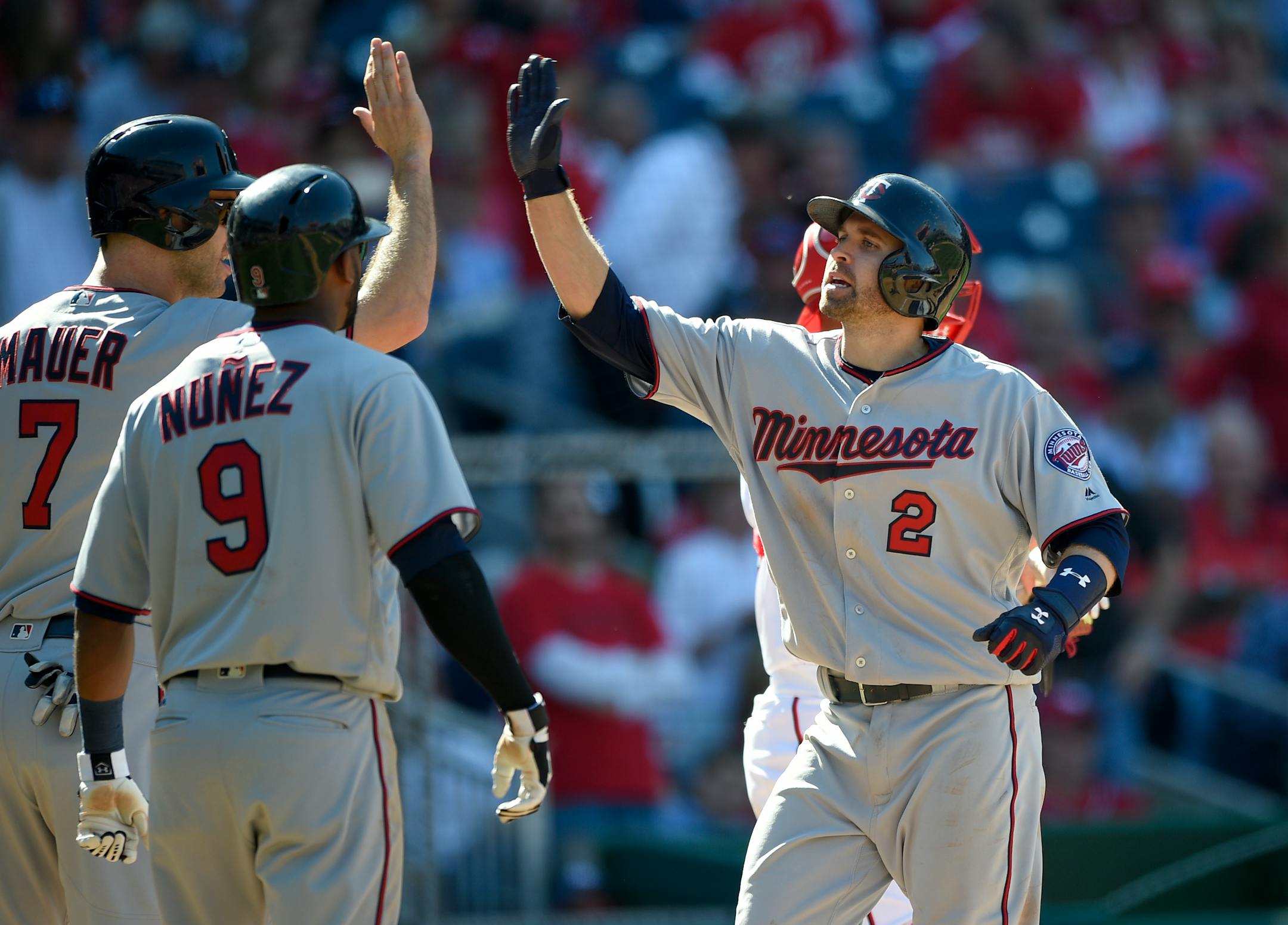 The Twins' Brian Dozier (2) celebrated his three-run home run with Joe Mauer (7) and Eduardo Nunez during the eighth inning against the Nationals, but Washington rallied twice and eventually pulled out a 6-5 victory in 16 innings.