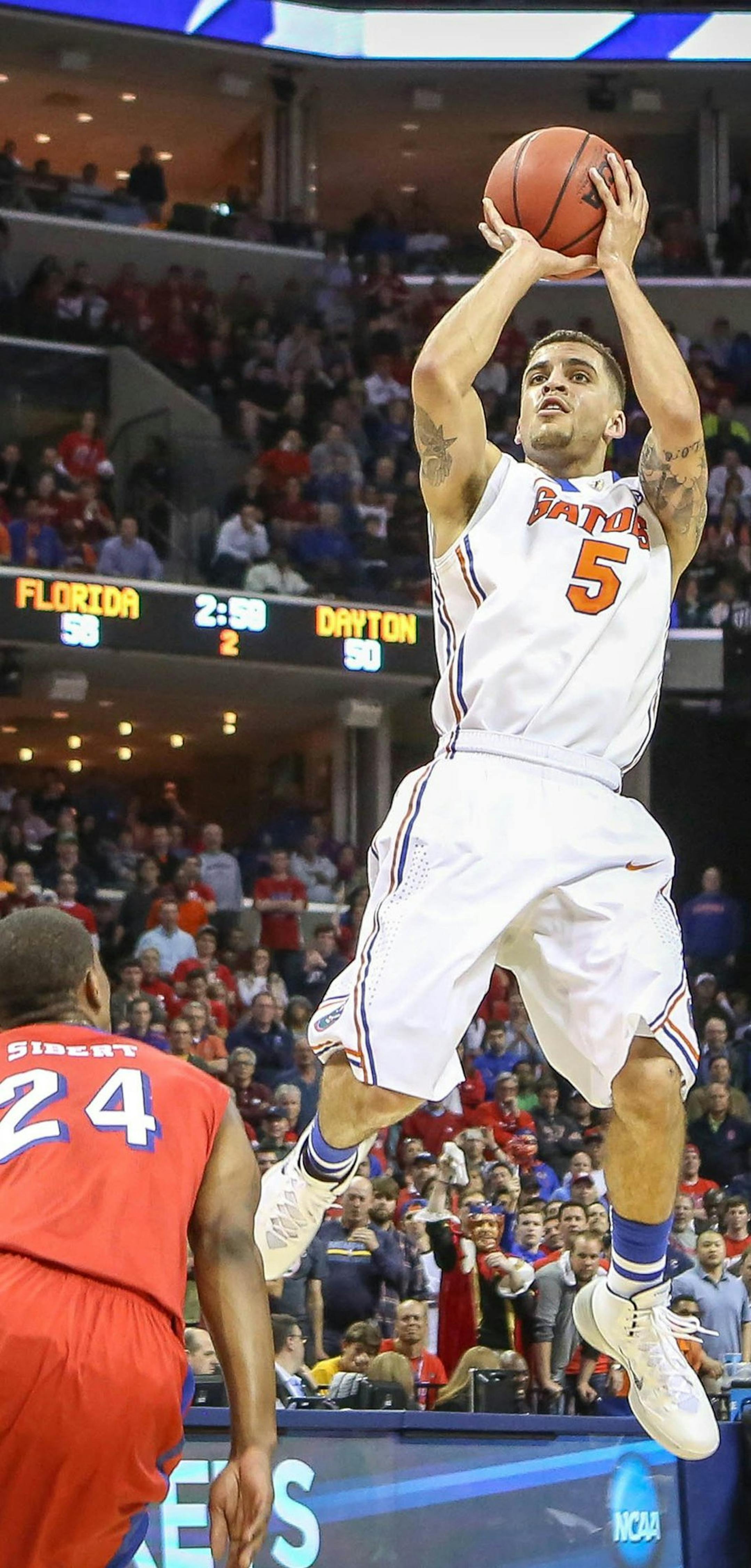 Florida's Scottie Wilbekin (5) shoots over Dayton's Jordan Sibert (24) during the second half in the NCAA Tournament's South Region final at the FedExForum in Memphis, Tenn., Saturday, March 29, 2014. Florida advanced, 62-52. (Joshua C. Cruey/Orlando Sentinel/MCT) ORG XMIT: 1151025