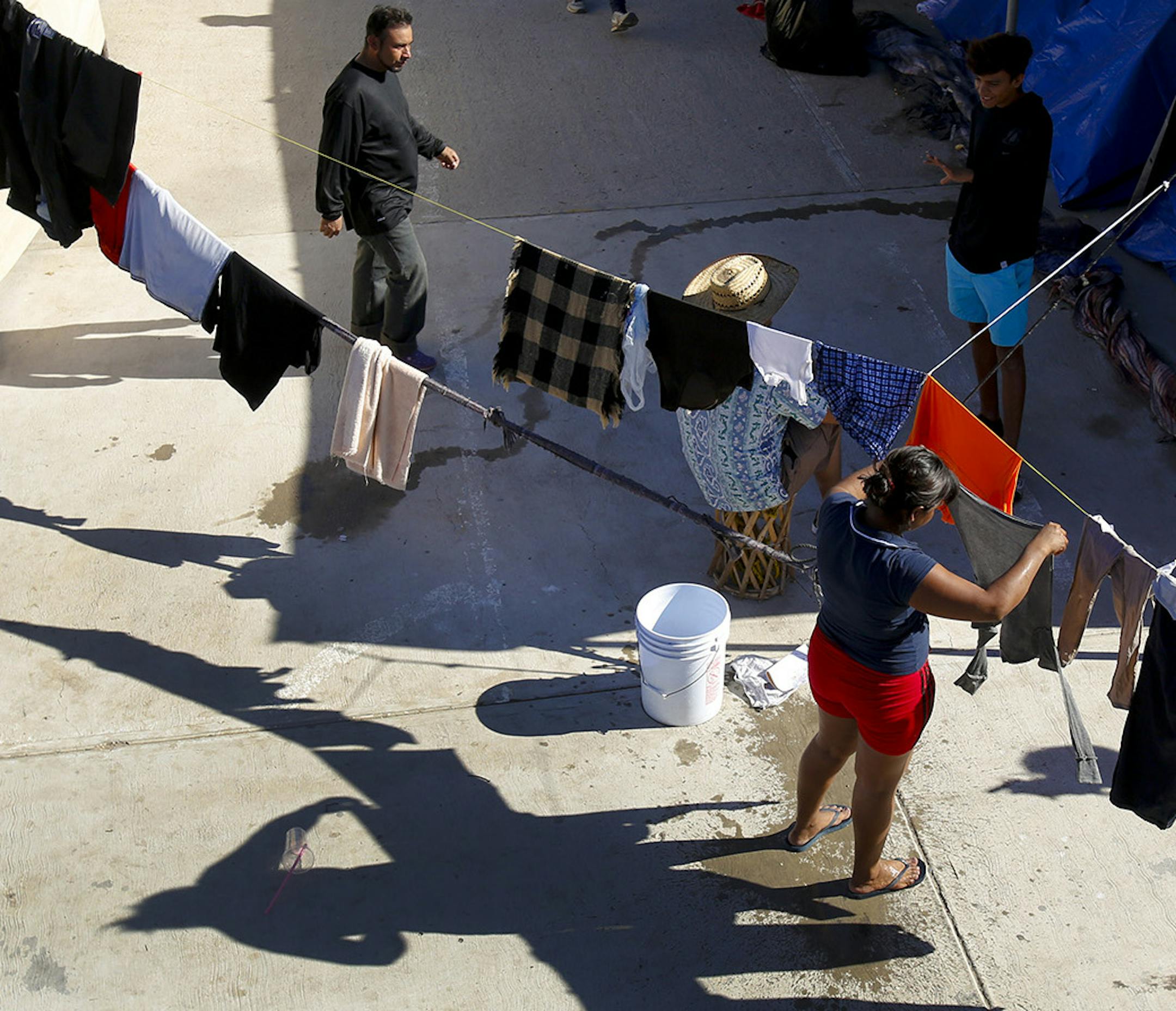 Every available space is used to hang clean, wet laundry at the El Barretal migrant shelter in Tijuana. (Nelvin C. Cepeda/San Diego Union-Tribune/TNS)