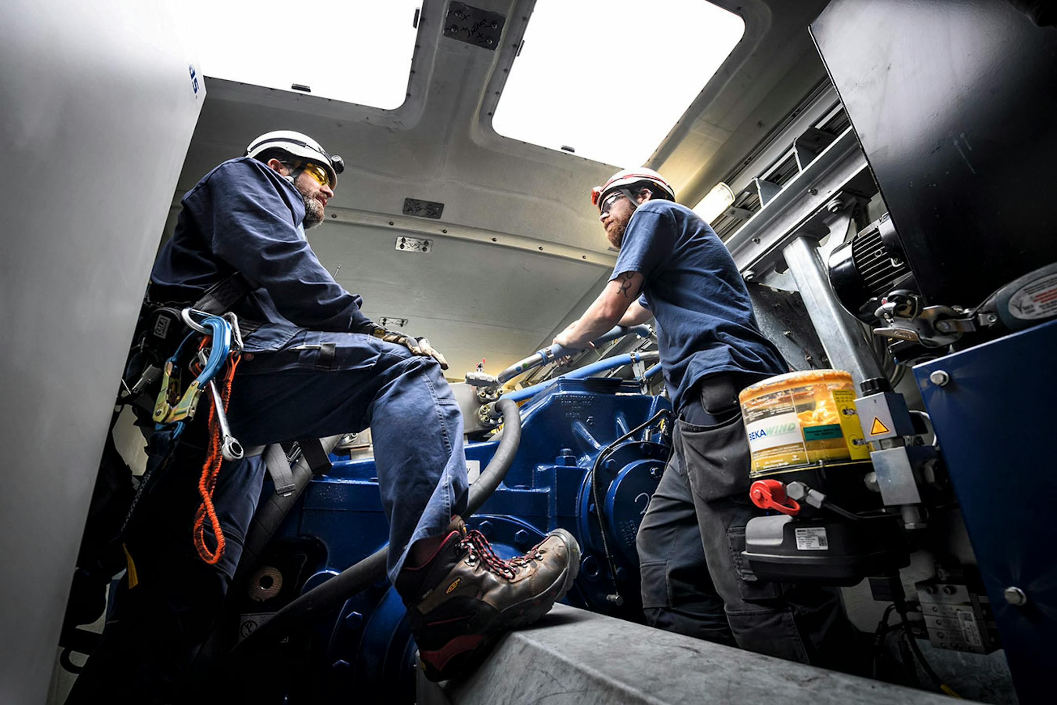 Inside the nacelle of a Vestas wind turbine, 300 feet in the air, Will Osborn and Shane Keck prepared for the climb down.