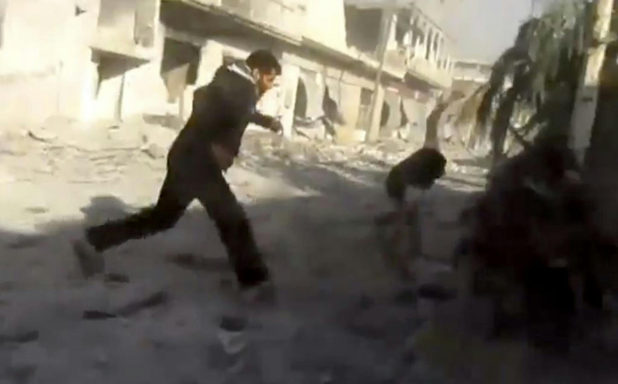 This image taken from video obtained from Shaam News Network, which has been authenticated based on its contents and other AP reporting, men running during heavy bombing from military warplanes in Houla, Syria, Tuesday, Nov. 6, 2012. The Britain-based Syrian Observatory for Human Rights said air raids on Houla, a group of villages in central province of Homs, killed several people.