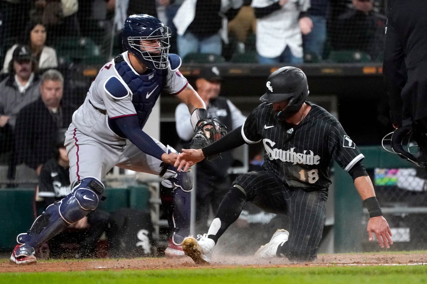 Chicago White Sox's AJ Pollock (18) scores in front of Minnesota Twins catcher Gary Sanchez during the seventh inning of a baseball game Monday, Oct. 3, 2022, in Chicago. (AP Photo/Charles Rex Arbogast)