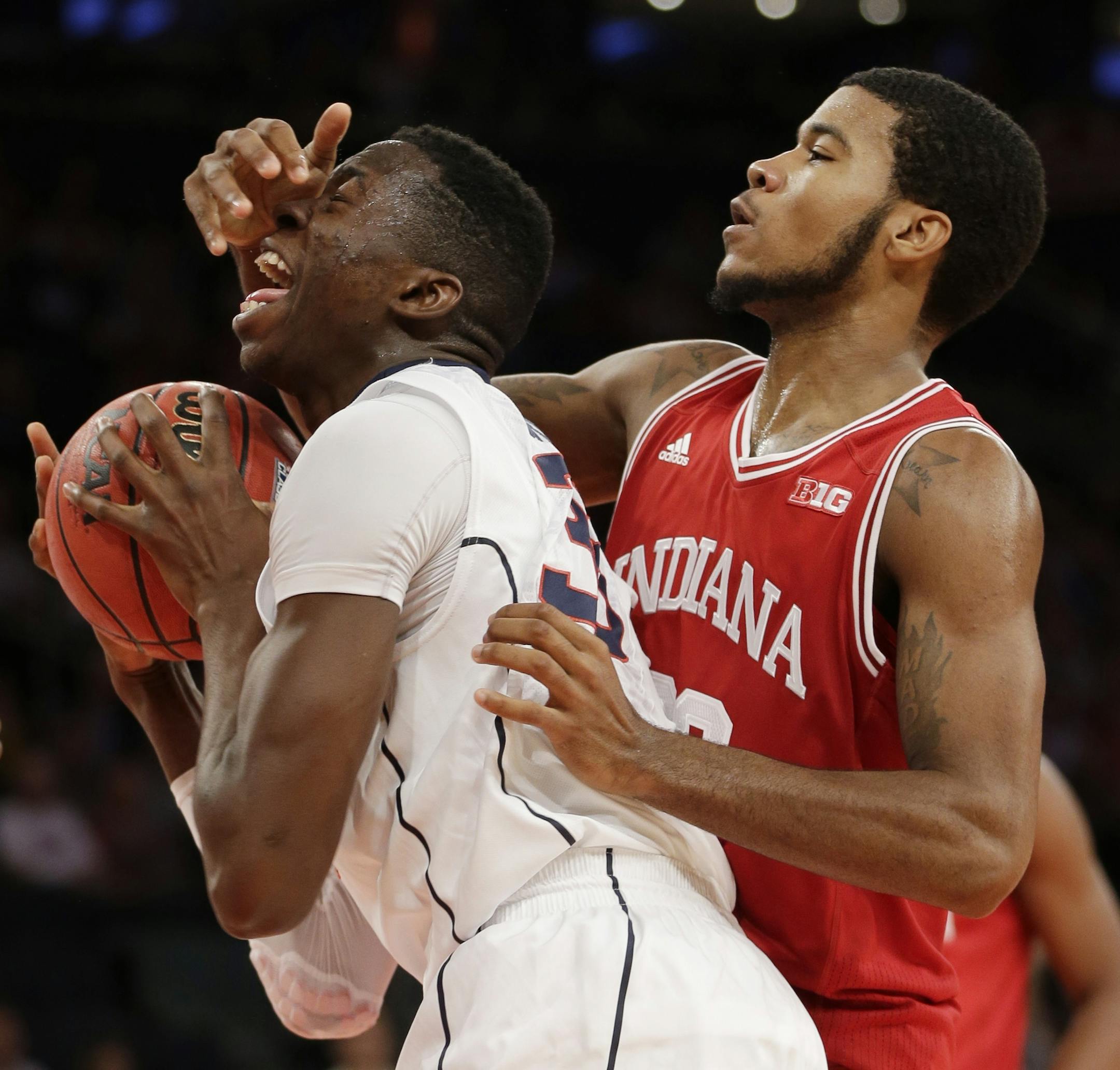 Connecticut's Amida Brimah, left, and Indiana's Jeremy Hollowell fight for a rebound during the first half of an NCAA college basketball game on Friday, Nov. 22, 2013, in New York. (AP Photo/Seth Wenig)