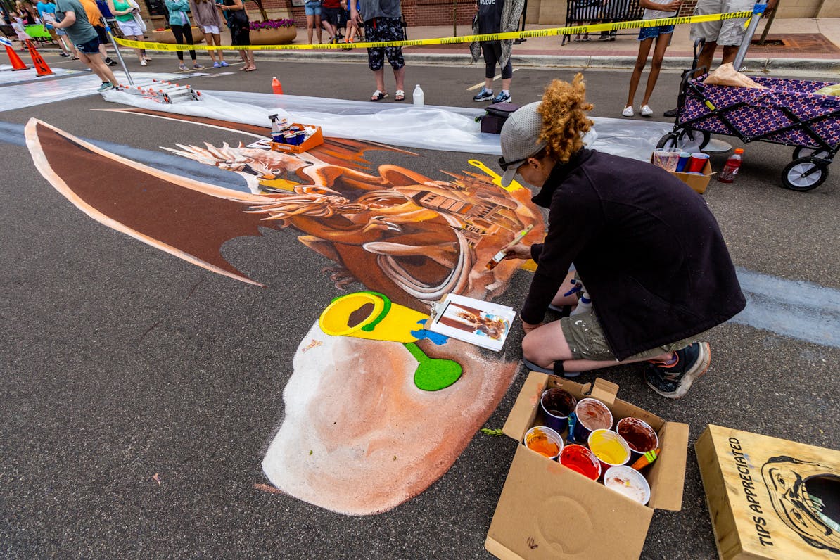 An artist creates a chalk design at 2023's Chalkfest.