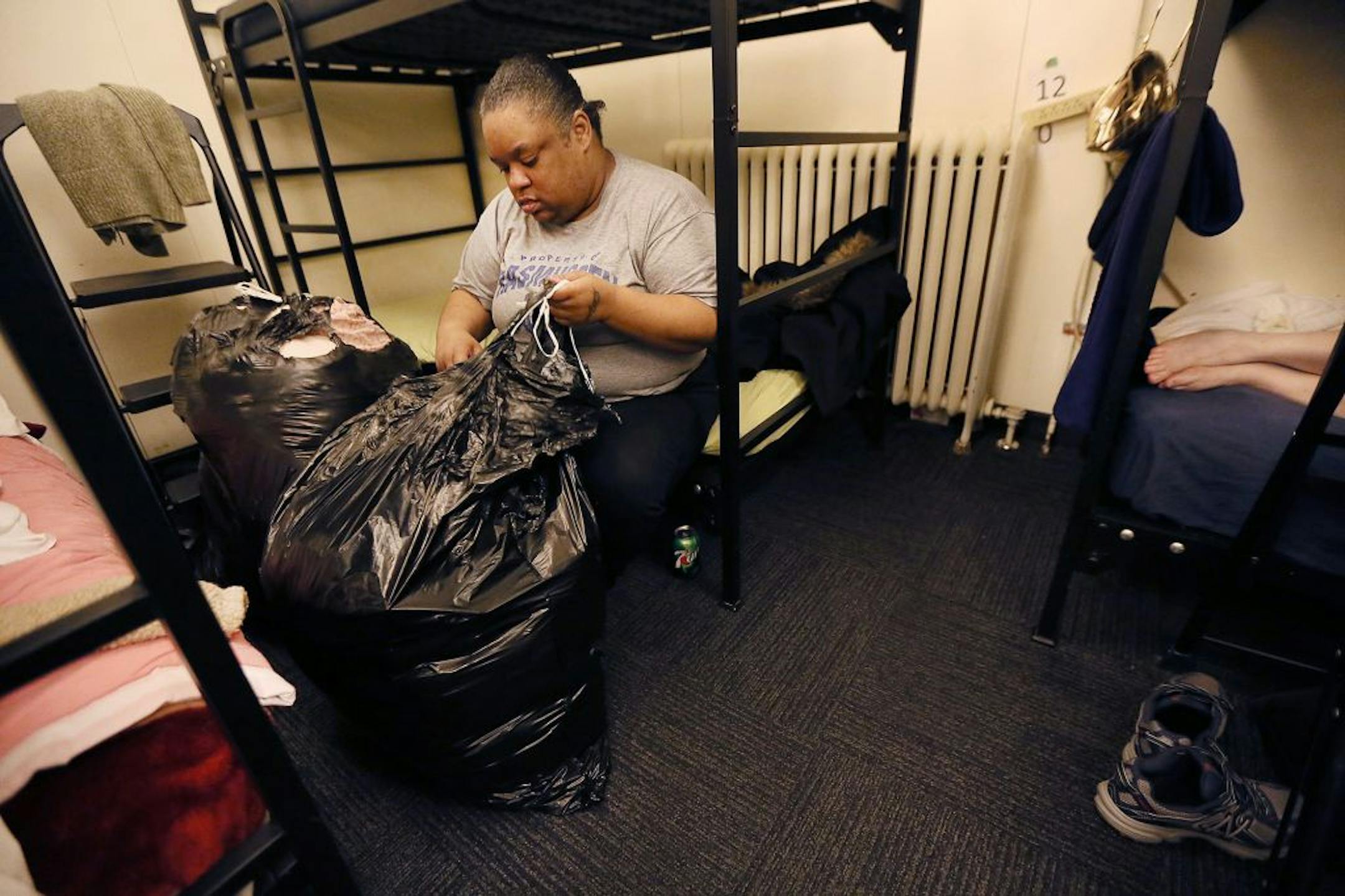 Mandisha Kelley packed her bedding into a plastic garbage bag to be stored away at the Simpson Housing Shelter, Friday, February 12, 2016 in Minneapolis, MN.