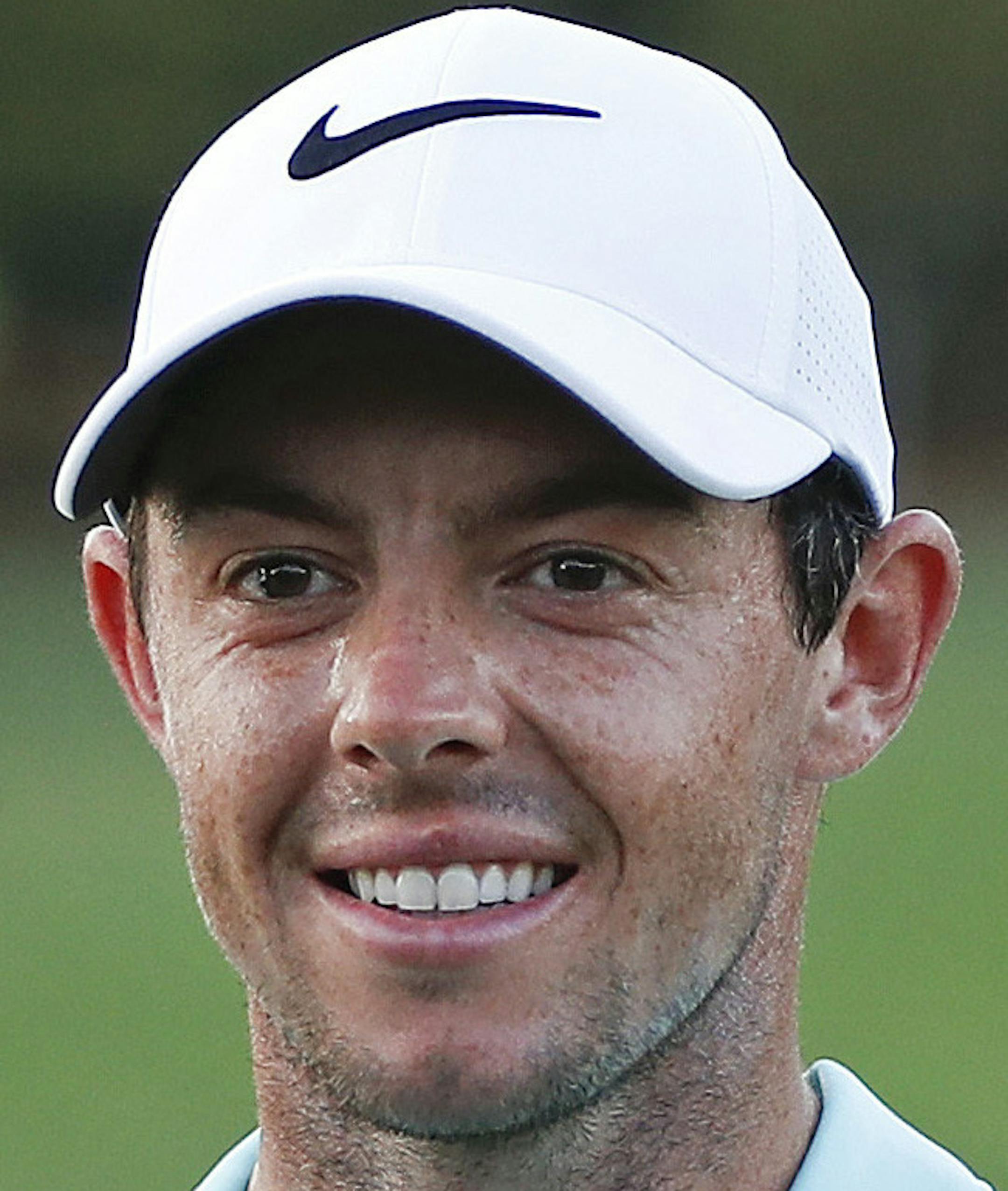 Rory McIlroy poses with the trophies after winning the Tour Championship golf tournament and FedEX Cup at East Lake Golf Club, Sunday, Sept. 25, 2016, in Atlanta. (AP Photo/John Bazemore)