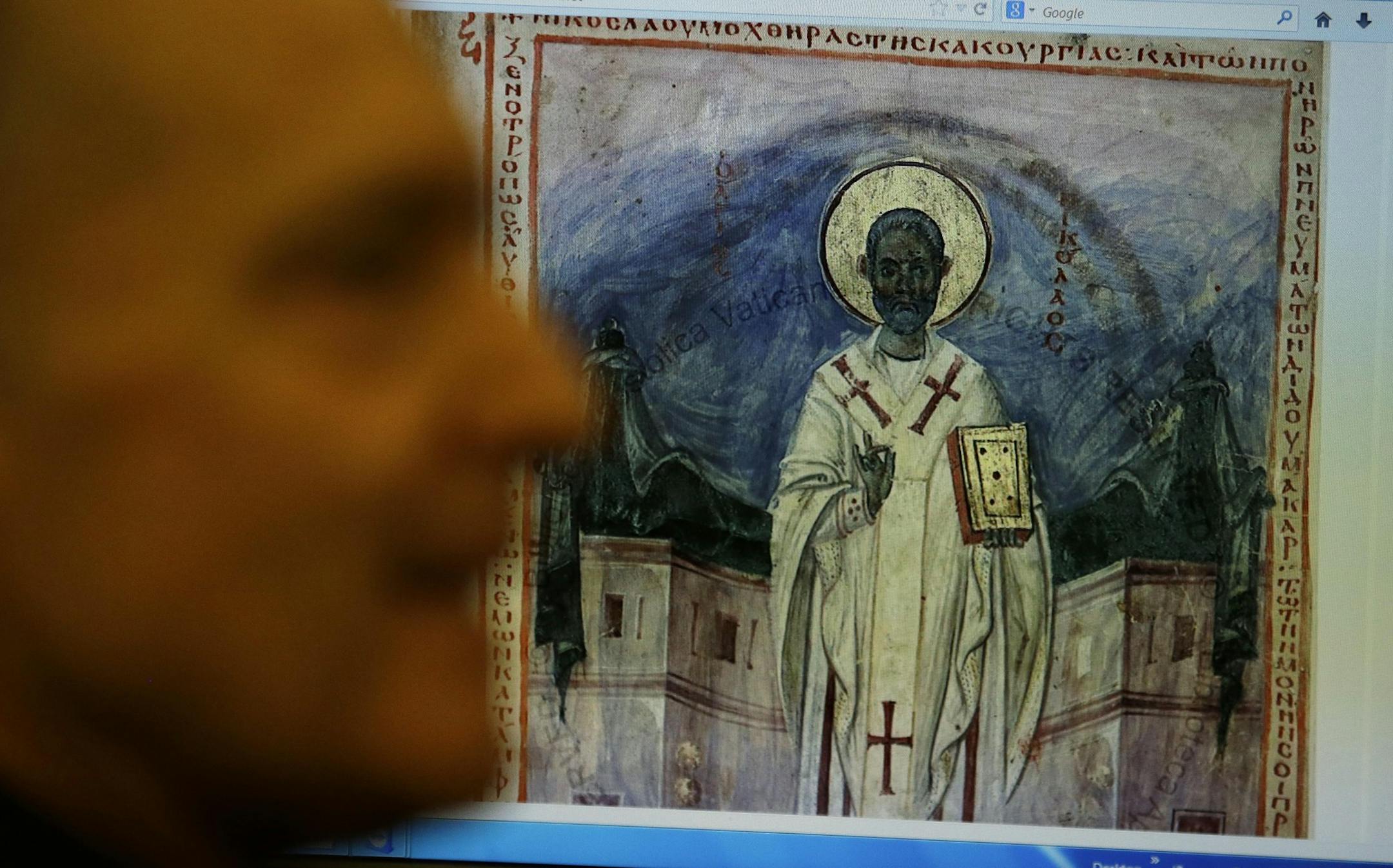Msgr. Cesare Pasini, prefect of the Vatican Apostolic Library, shows a 10th century digitalized Bible during an interview with The Associated Press , at the Apostolic Library, at the Vatican, Tuesday, Dec. 3, 2013. The Vatican Library and Oxford University's Bodleian Library put the first of 1.5 million pages of ancient manuscripts online Tuesday, bringing their full two-volume Gutenberg Bibles and other precious documents to a global audience for the first time. The two libraries in 2012 announ