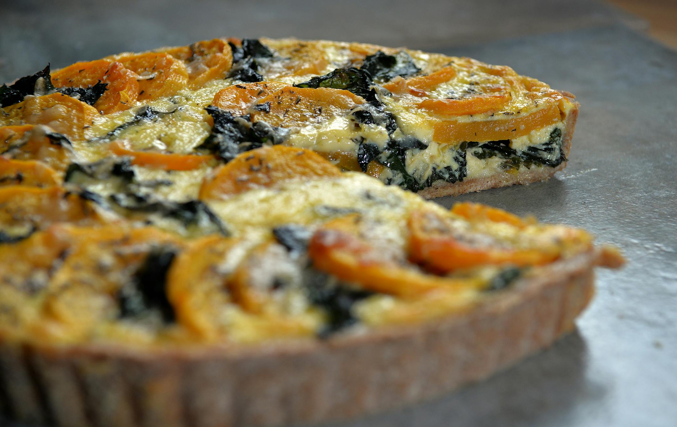 Squash and Chard Tart is a savory mix of sweet butternut squash, earthy chard and creamy, salty Fontina cheese in an eggy custard.