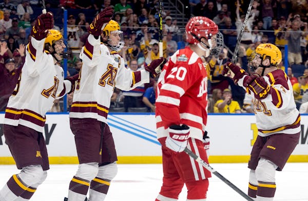 Gophers defenseman Mike Koster, right, celebrated with teammates after scoring in Thursday’s 6-2 NCAA semifinal victory against Boston University in