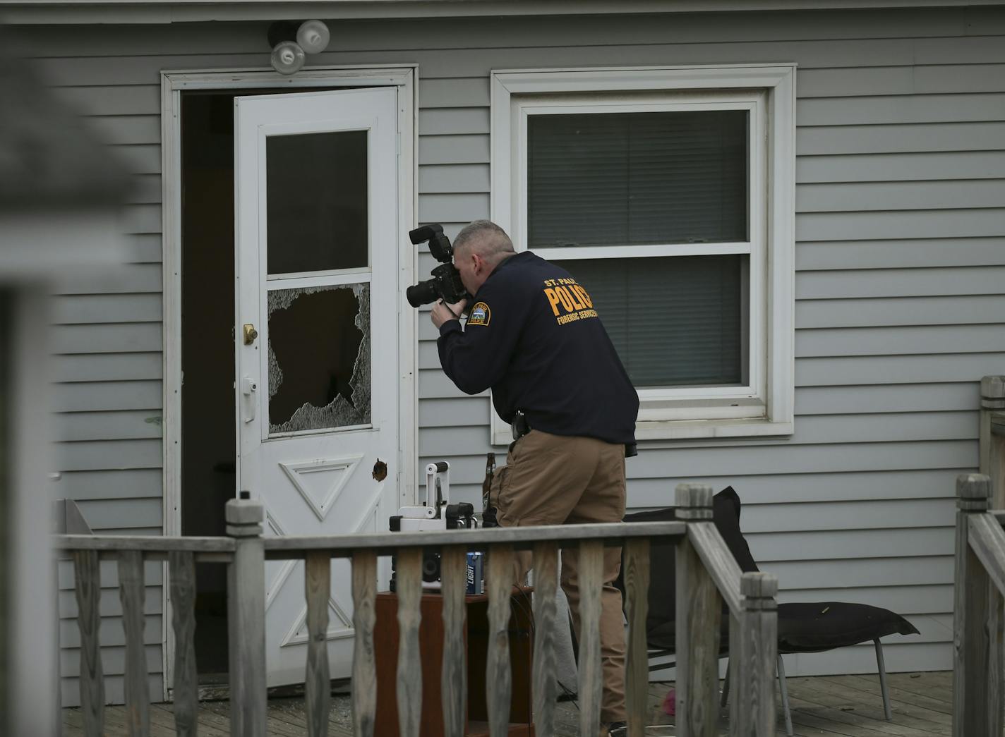 A St. Paul police investigator photographed the back door of a house where a man was shot by officers Monday afternoon on the city&#x2019;s East Side.