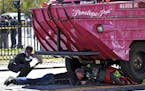 FILE - In this April 30, 2016, file photo, investigators work the scene of an accident involving a duck boat where a woman died after the scooter she 