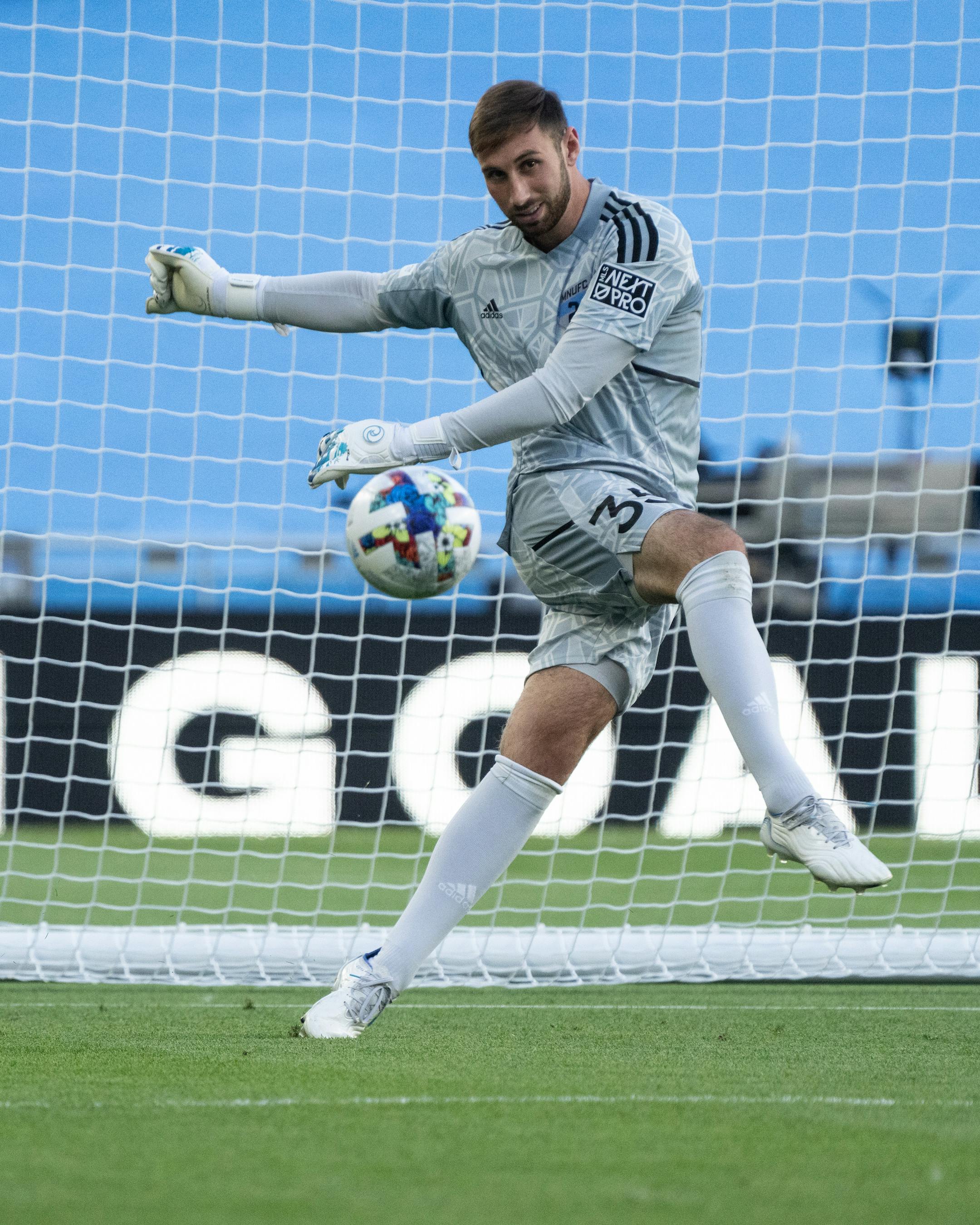 Minnesota United FC goalkeeper Alec Smir kicks the ball during a Goalie Wars challenge.