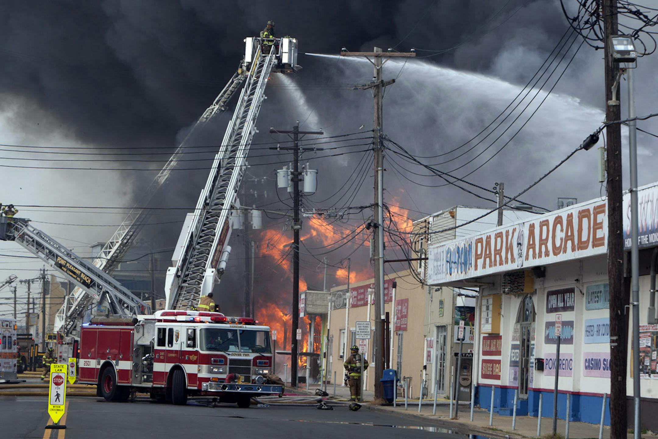 Firefighters battle a fire on the Seaside Heights, N.J. boardwalk Thursday, Sept. 12, 2013.