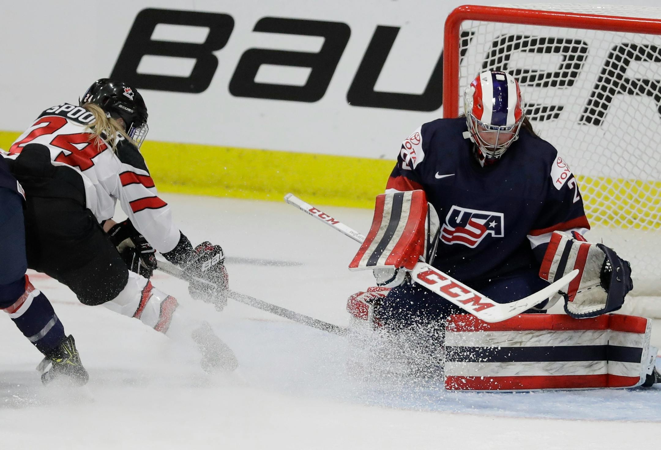 United States goalie Nicole Nensley stops a shot by Canada forward Natalie Spooner (24) during the first period of a IIHF Women's World Championship hockey tournament game, Friday, March 31, 2017, in Plymouth, Mich. (AP Photo/Carlos Osorio)