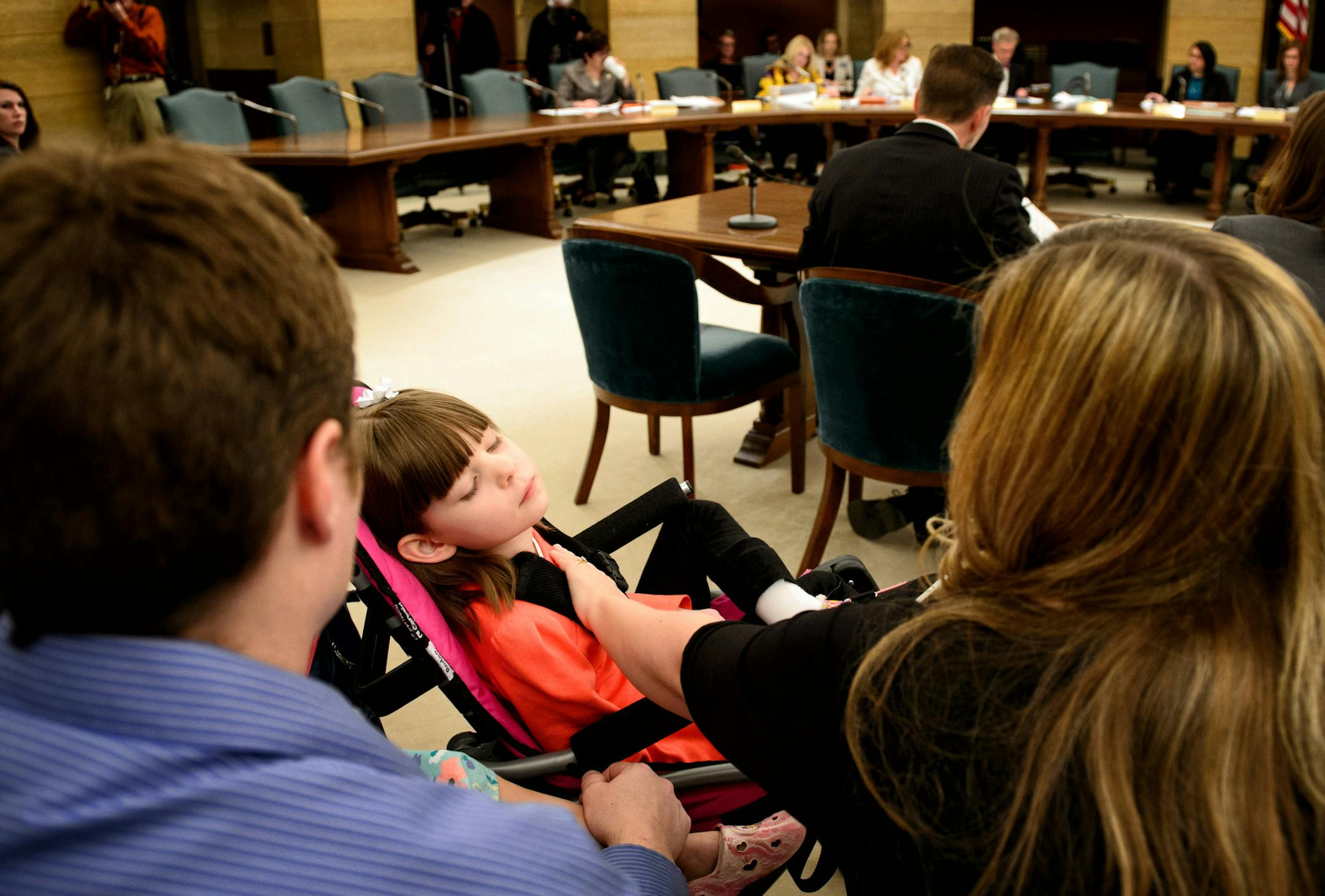 Angie Weaver comforted her daughter Amelia, 7, at a Senate hearing about a medical marijuana bill Thursday at the State Capitol. Amelia suffers from a rare form of epilepsy, called Dravet Syndrome, that can be effectively treated with a substance extracted from marijuana, which is currently illegal in Minnesota.