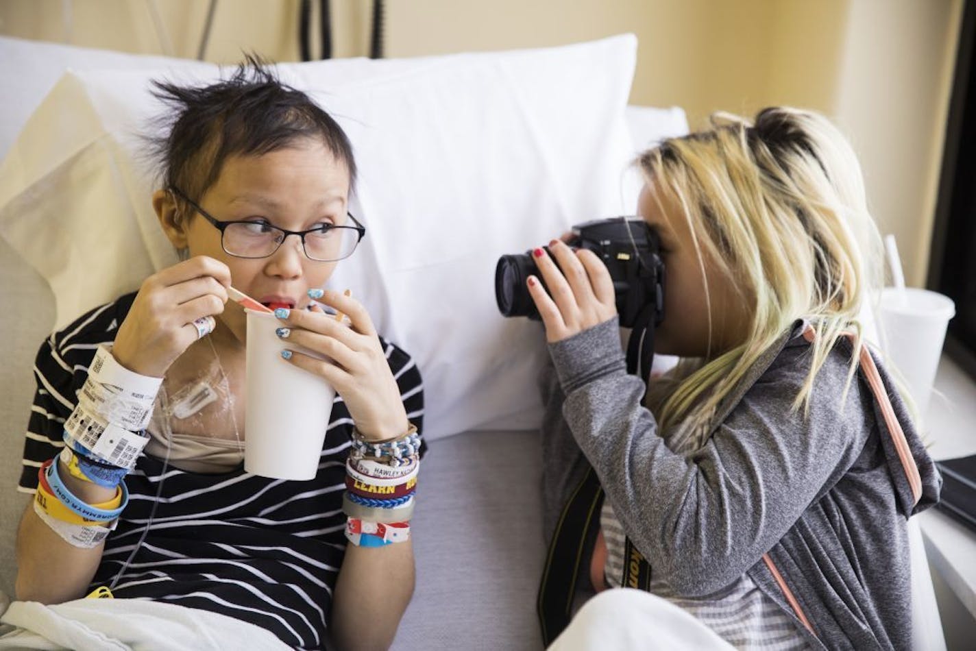 Nat Hawley, left, 14, poses for her sister Gabi Augusta, 10, during one of Nat's chemotherapy appointments.