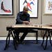 Jarrelle Barton adjusted his guzheng as he practiced in his studio space.