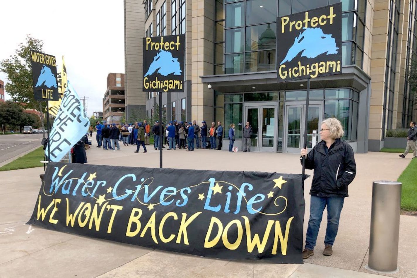 Opponents of Enbridge Energy's plan to replace its aging Line 3 crude oil pipeline across northern Minnesota, protest Tuesday, Oct. 1, 2019, in St. Paul, before a state Public Utilities Commission meeting on the project. State utility regulators have unfrozen the approval process for Enbridge Energy's plan to replace its aging crude oil pipeline across Minnesota.