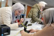 Marta Lukasewycz of Edina fills out information before voting in the presidential primary.