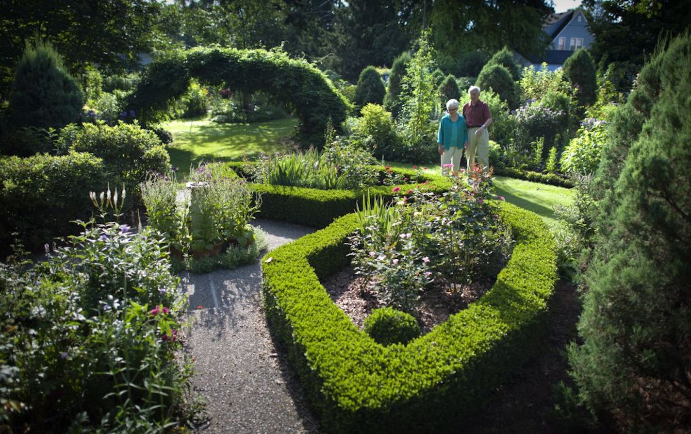 Lee and Jerry Shannon planted colorful shrub roses in the center of pruned boxwoods that shape their formal garden.