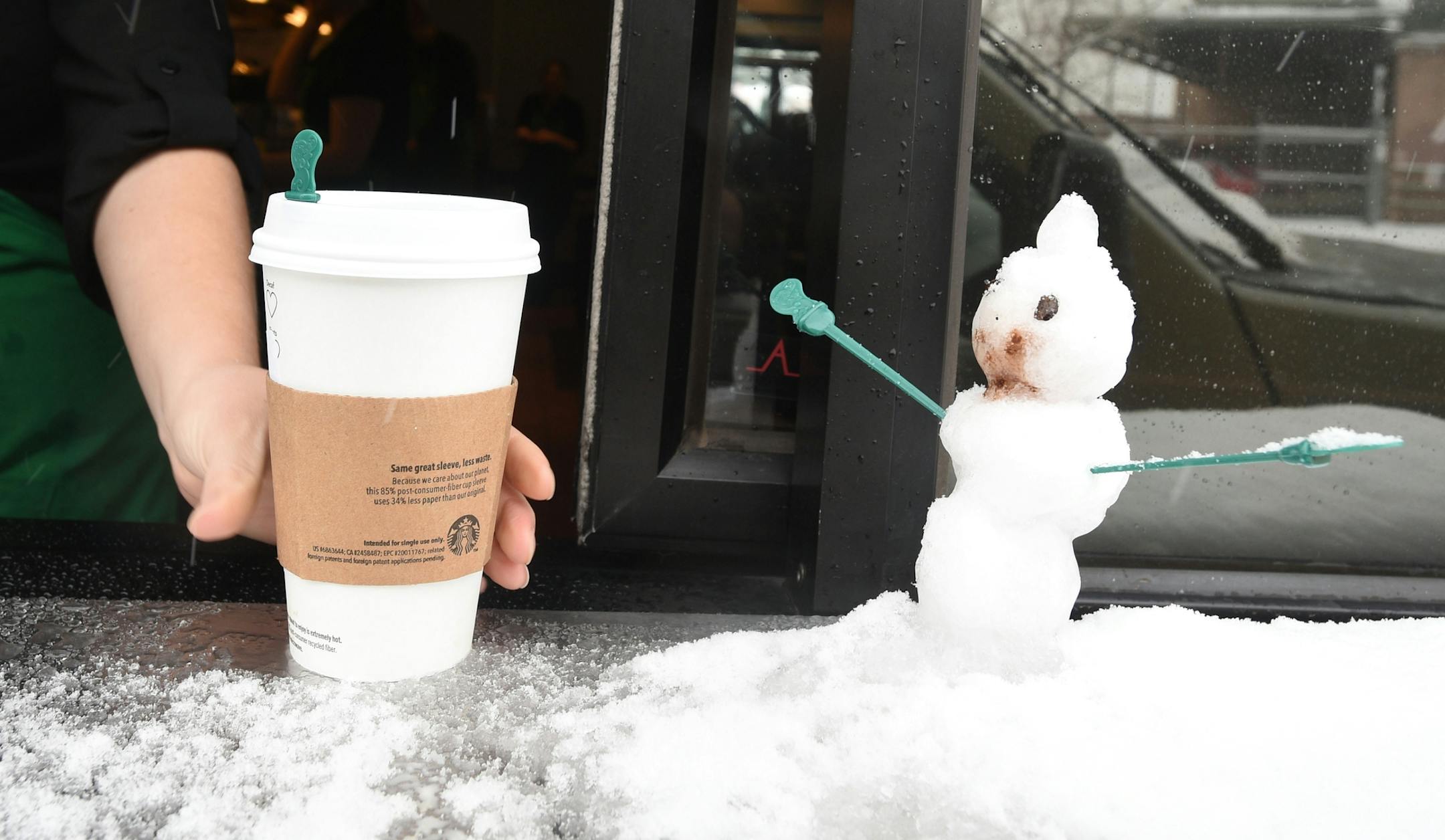 A little snowman with stir sticks as arms sits on the drive-thru window at a Starbucks in Colorado Springs, Colo., on Monday, Feb. 16, 2015. Snowstorms moved in and out numerous times during the day in the Pikes Peak region. (AP Photo/The Gazette, Jerilee Bennett) MAGS OUT