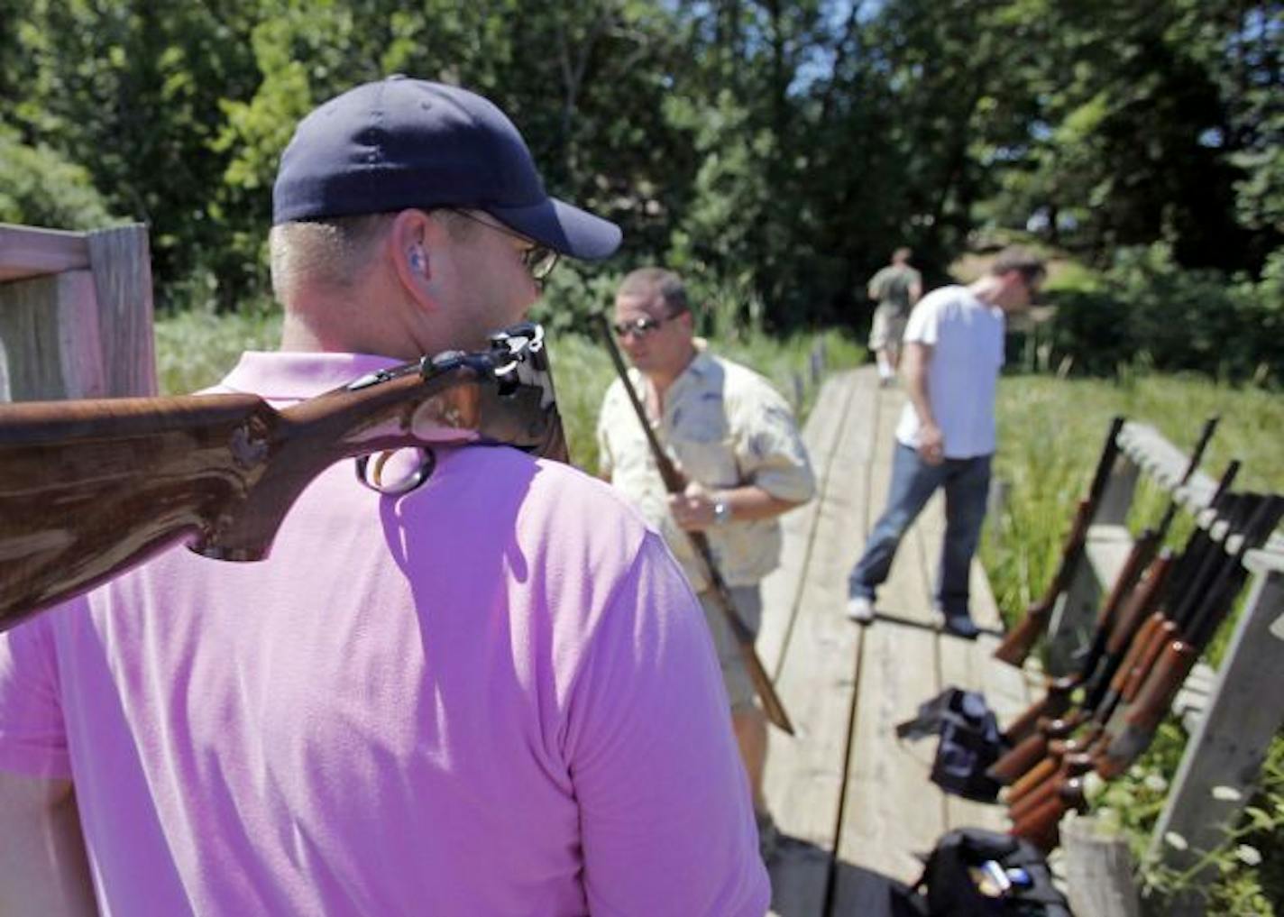 A group of businessmen from the Twin Cities and Birmingham, Ala., mixed business and pleasure on the skeet range at Minnesota Horse and Hunt Club in Prior Lake. Chad Nelson, left, of Delano, Minn., may have a new place to shoot if the DNR finds a site for a $22 million shooting complex.