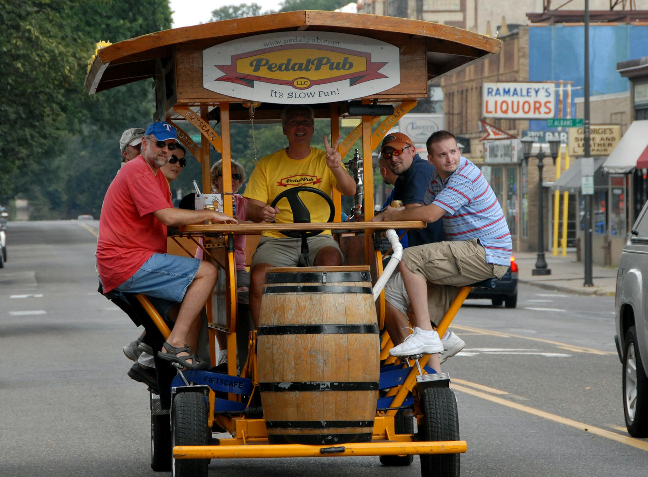Riders on the PedalPub going down Grand Ave. in St. Paul.