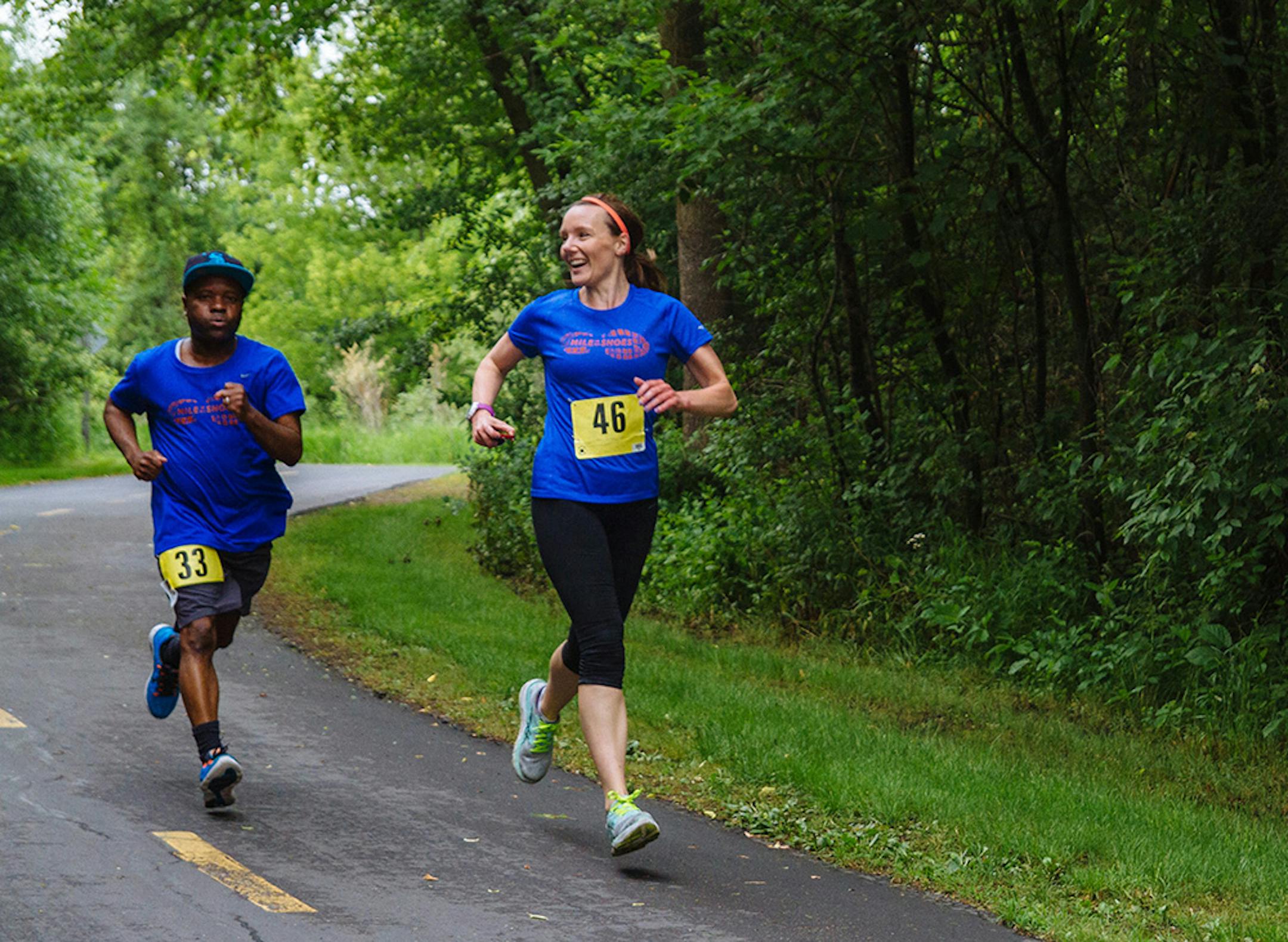 Mishka Vertin, right, of Mile in My Shoes nonprofit, ran with a resident at a local race.