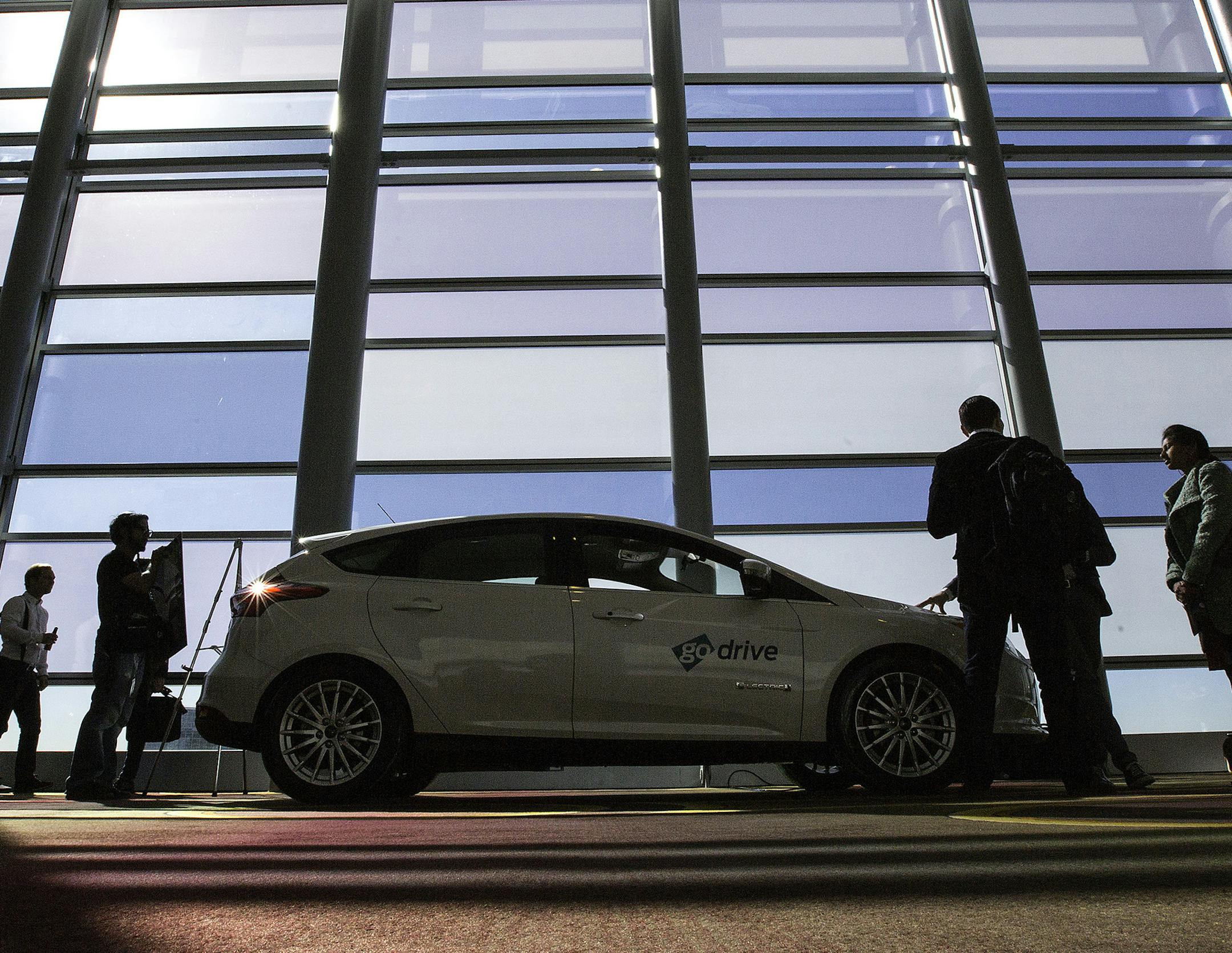 Attendees at the Connected Car Expo around the Ford Focus Electric at the JW Marriott on Nov. 17, 2015 in Los Angeles. (Brian van der Brug/Los Angeles Times/TNS) ORG XMIT: 1176871