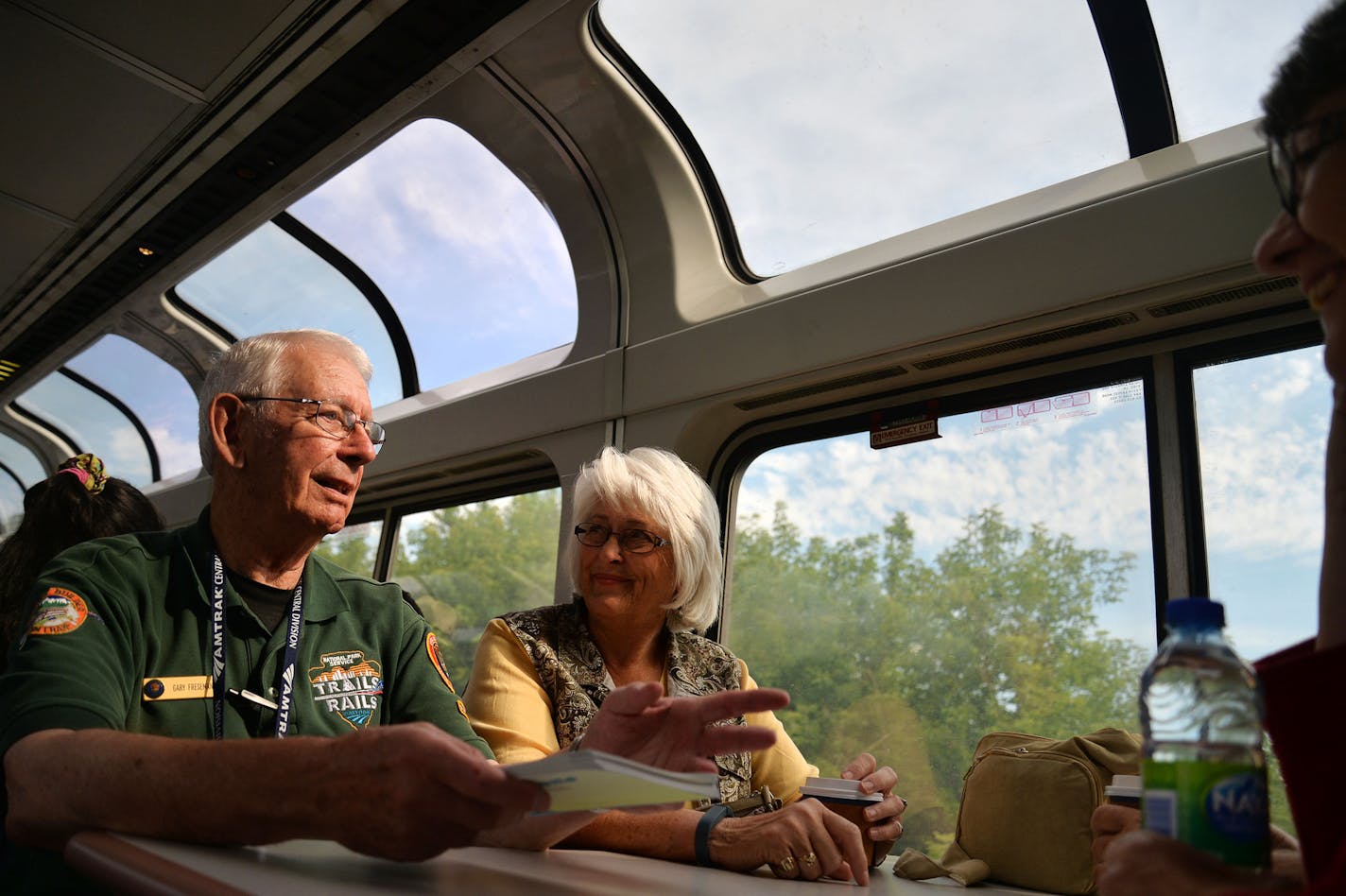 From left, Volunteer Master Ranger Corps Gary Freseman talked and joked with Carolyn Cohrs, of Wisconsin, and Sally Muegge, of Nebraska, as part of the Trails and Rails program on the Amtrak Train that departed from Union Depot in St. Paul, Minn. and went to Chicago, Illinois, on Monday July 27, 2015. ] RACHEL WOOLF &#xb7; rachel.woolf@startribune.com