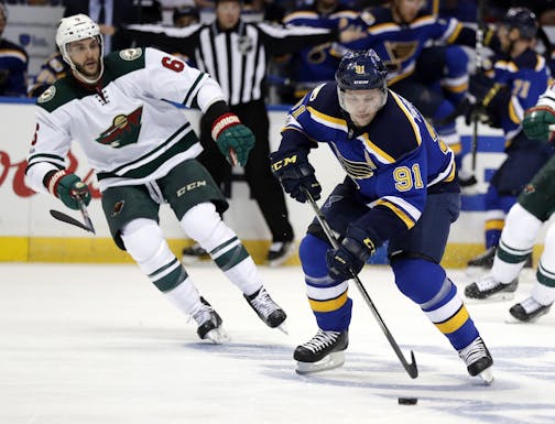 St. Louis Blues' Vladimir Tarasenko, of Russia, brings the puck down the ice as Minnesota Wild's Marco Scandella, left, watches during the second period in Game 4 of an NHL hockey first-round playoff series Wednesday, April 19, 2017, in St. Louis.