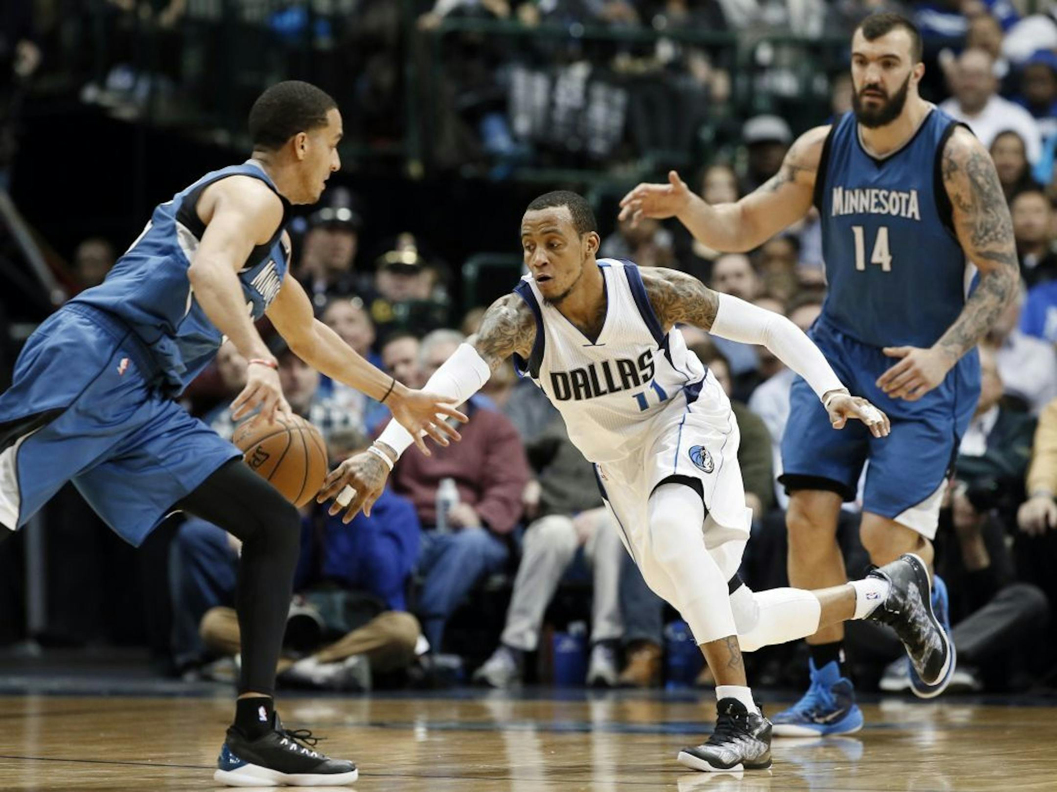 Dallas Mavericks guard Monta Ellis (11) sprints forward to control a steal from Minnesota Timberwolves' Kevin Martin, left, as Nikola Pekovic (14) of Montenegro, watches in the second half of an NBA basketball game, Monday, Feb. 2, 2015, in Dallas. The Mavericks won 100-94.
