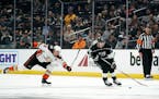Los Angeles Kings left wing Kevin Fiala, right, takes the puck as Anaheim Ducks right wing Jakob Silfverberg reaches for him during the second period 