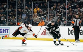 Los Angeles Kings left wing Kevin Fiala, right, takes the puck as Anaheim Ducks right wing Jakob Silfverberg reaches for him during the second period