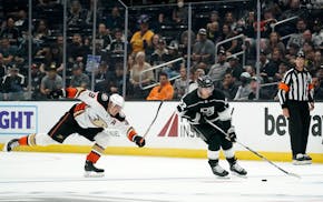 Los Angeles Kings left wing Kevin Fiala, right, takes the puck as Anaheim Ducks right wing Jakob Silfverberg reaches for him during the second period 